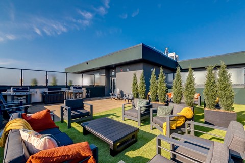 A patio area with a table, chairs, and couches.