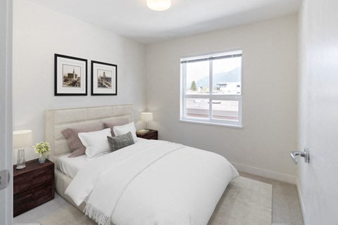 a bedroom with a large bed and two night stands with lamps
