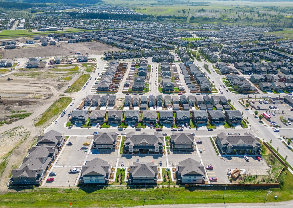 an aerial view of a neighborhood of houses in a parking lot
