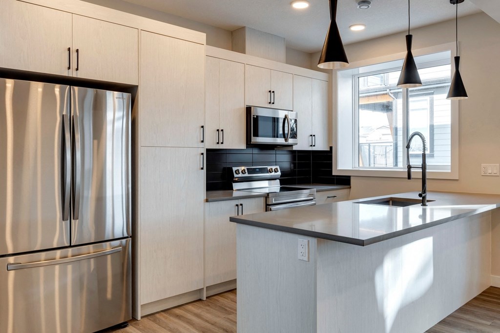 a kitchen with white cabinets and a large counter top