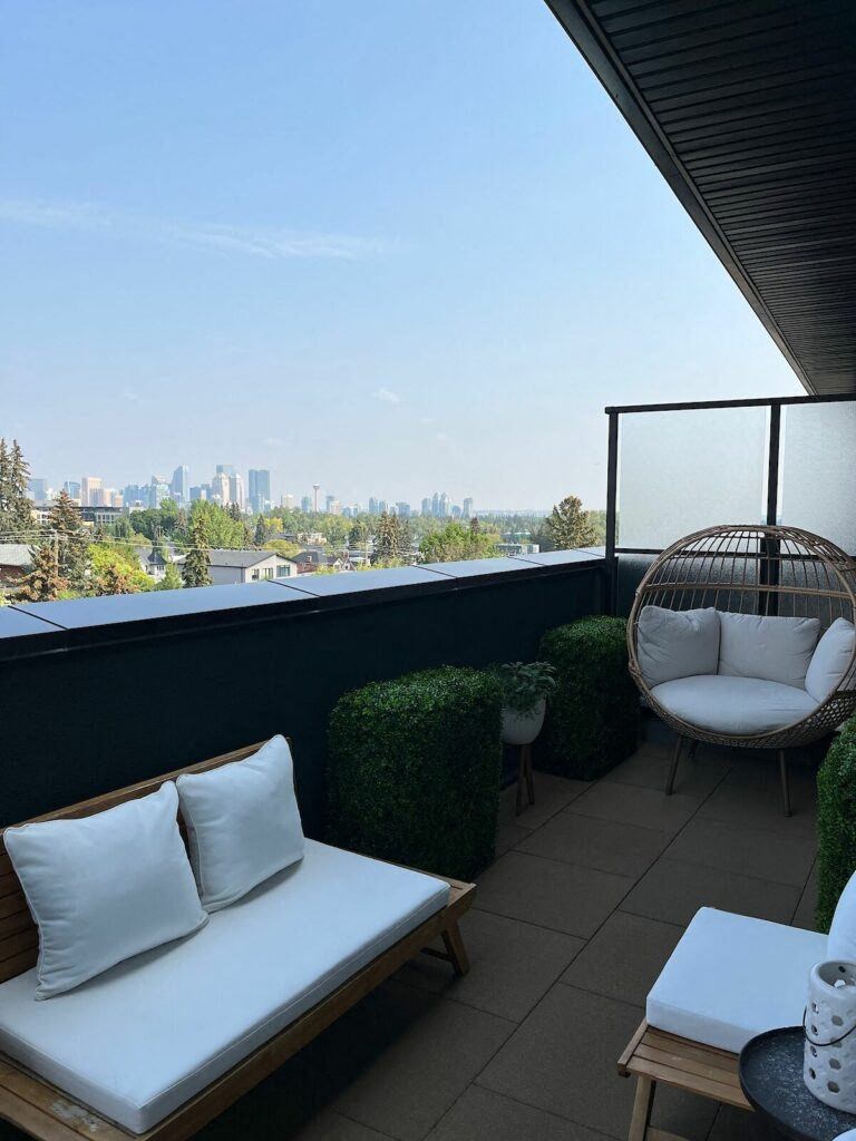 a balcony with a chair and a table