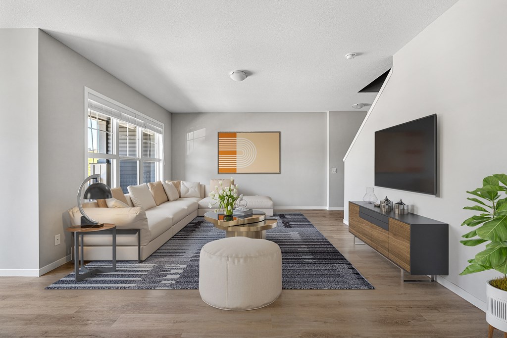 a living room with a white couch and a television