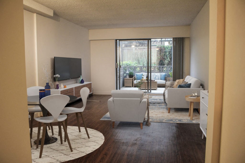 a living room with white furniture and a sliding glass door leading to a patio