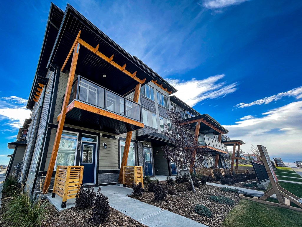 a home with a porch and a blue sky