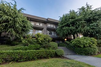 an apartment building with trees in front of it