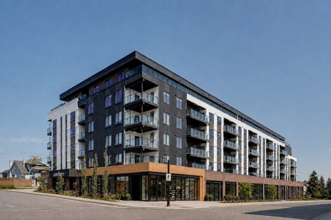 A modern multi-story building with balconies on the upper floors.