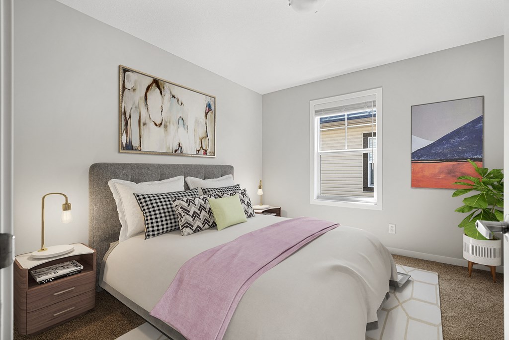 a bedroom with a large bed and a window
