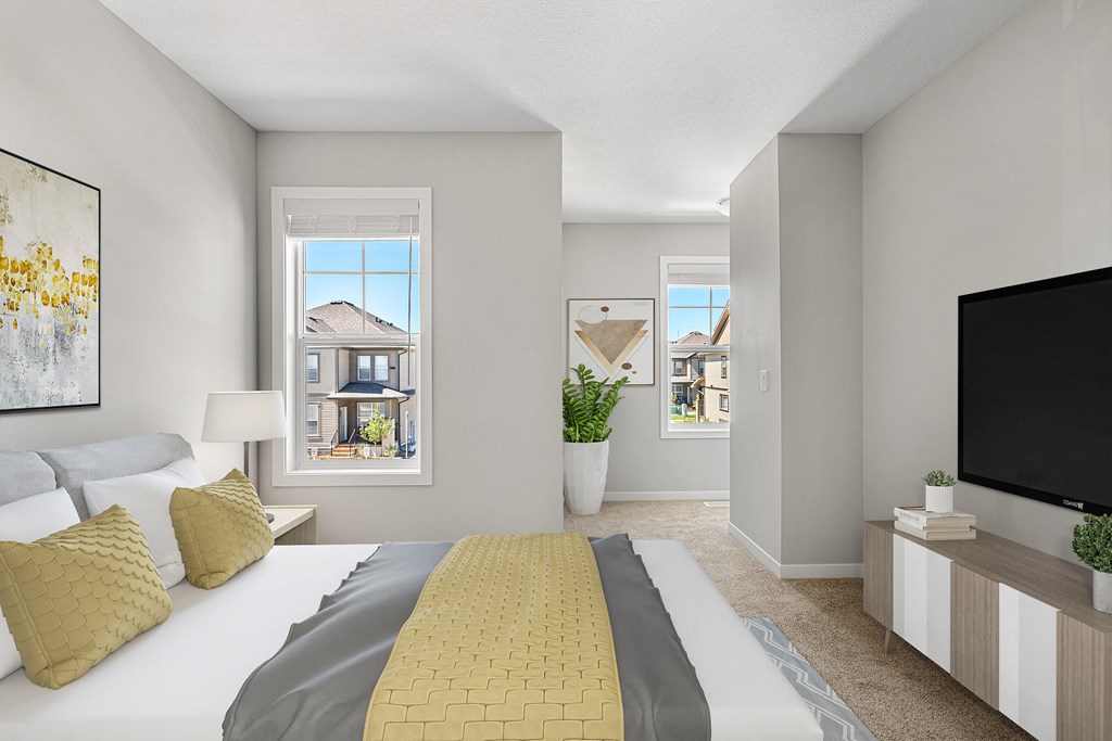 a bedroom with a large bed and a tv