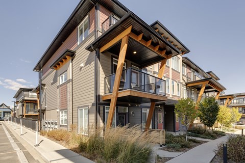 A modern house with a balcony and a wooden roof.