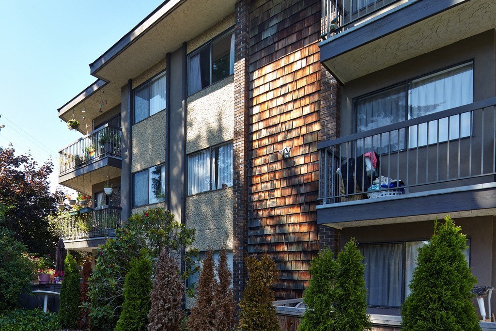 an apartment building with a dog on a balcony