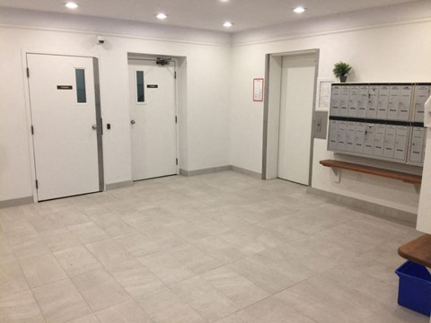 a room with three doors and a table with a filing cabinet
