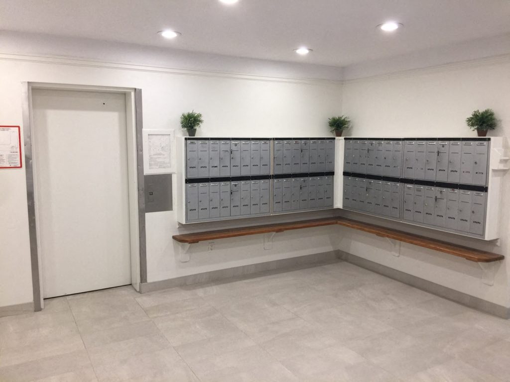 a locker room with lockers and plants on the wall
