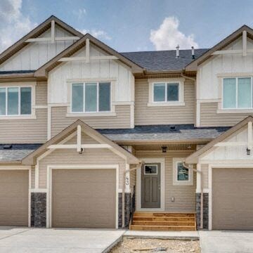 a house with two garages in front of it