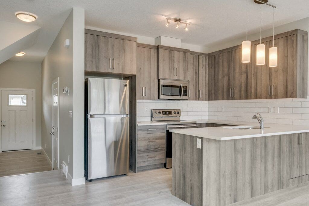 a kitchen with wooden cabinets and a white counter top
