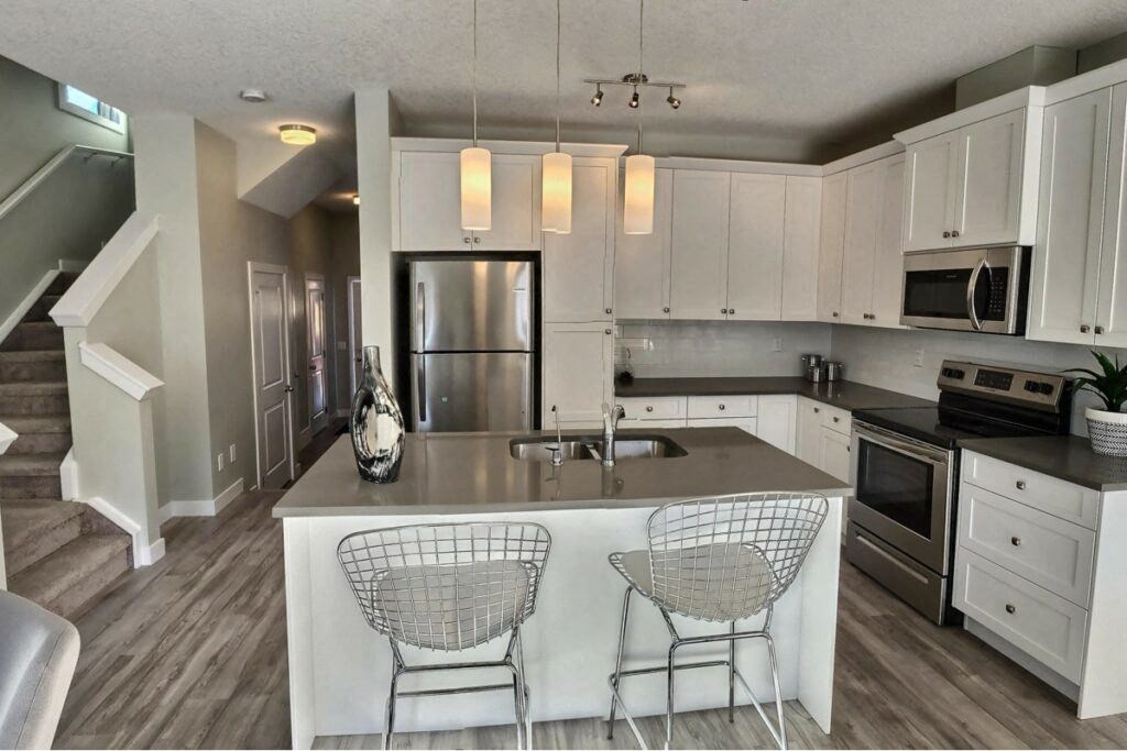 a kitchen with a center island next to a stove top oven