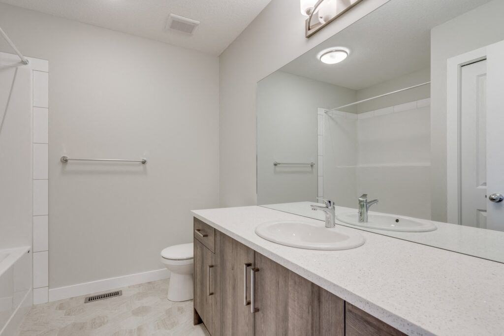 a bathroom with a toilet sink and shower