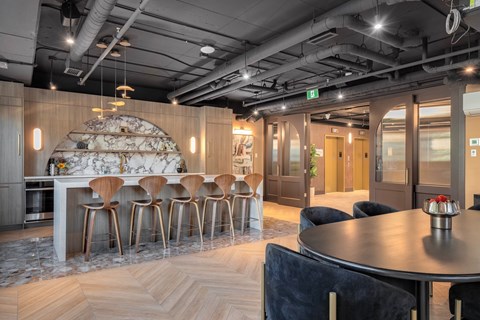A modern dining area with a round table and chairs.