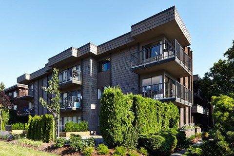 a picture of an apartment building with a blue sky in the background