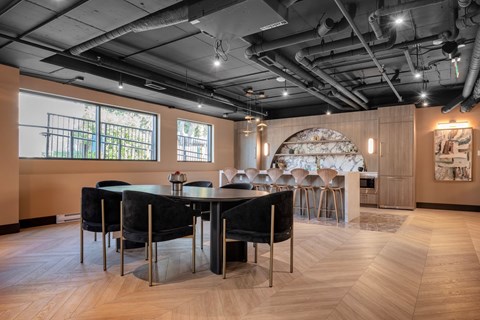 A modern dining room with a large table and chairs.