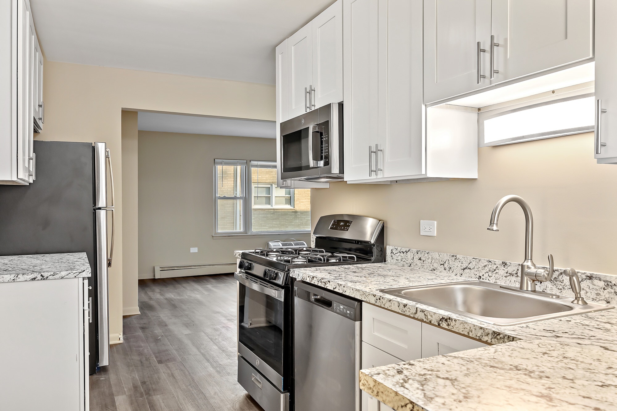 A kitchen with a stainless steel dishwasher and oven.