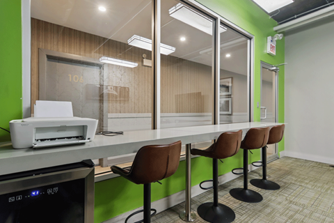 A row of chairs are lined up in front of a counter.