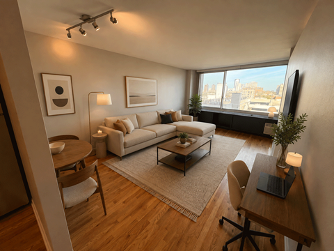 A modern living room with a large window overlooking the city.