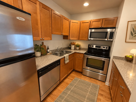 A kitchen with wooden cabinets and stainless steel appliances.
