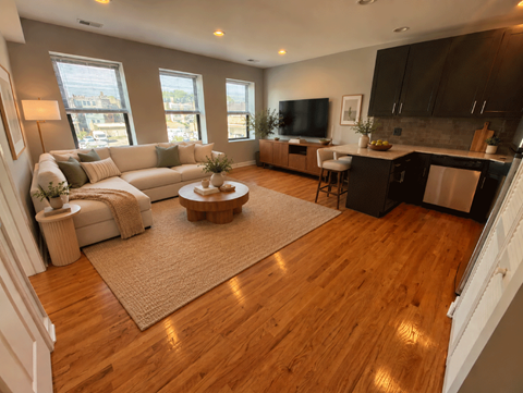 A living room with a white couch and a coffee table.
