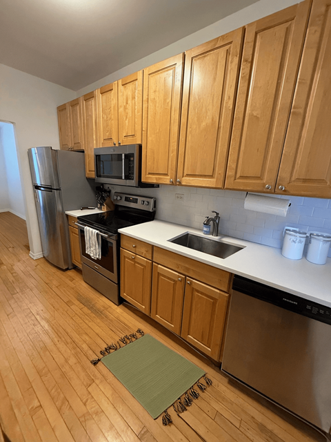 A kitchen with wooden cabinets and stainless steel appliances.