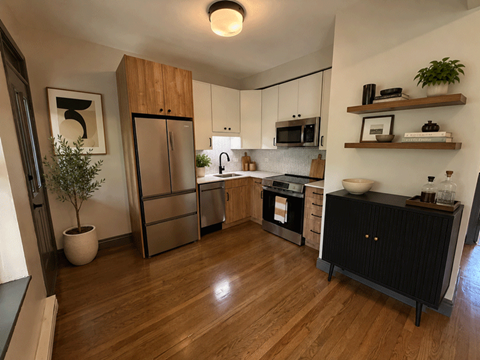 A kitchen with wooden floors and a black cabinet.