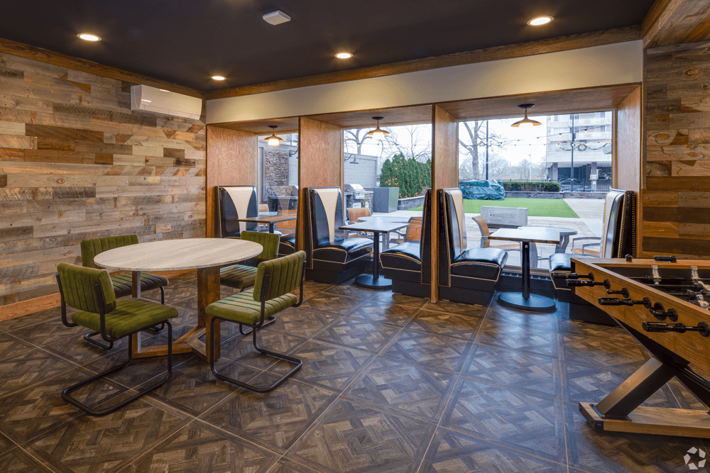 A room with a table and chairs and a pool table at The Bryn - 5600 N Sheridan Rd Apartments, Chicago, IL, 60660