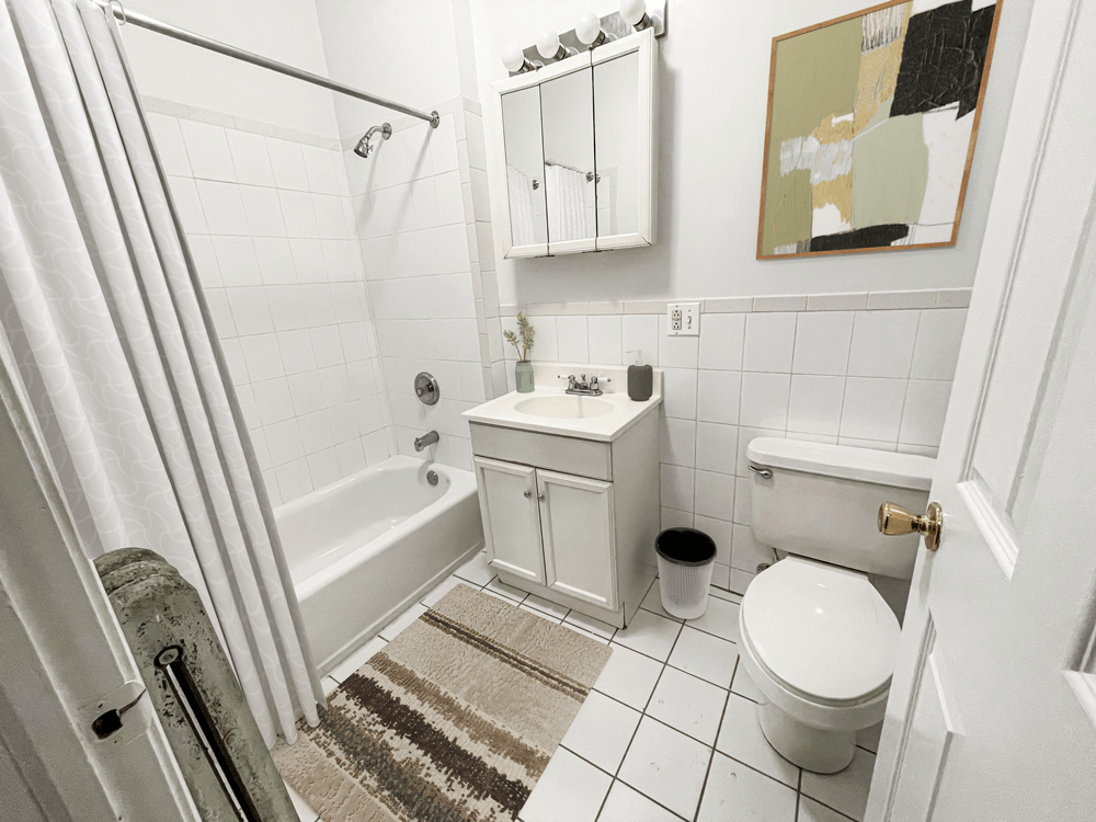 Barry Court White Bathroom with a shower sink and toilet