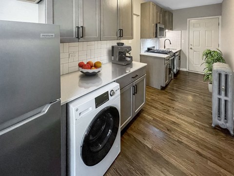 a kitchen with a washing machine and a dishwasher in it