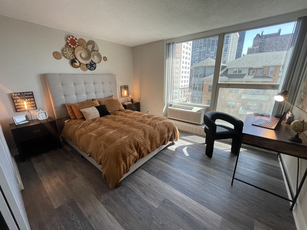 a bedroom with a large bed and a large window