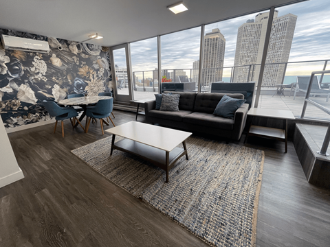 a living room with a view of the city and a couch and coffee table