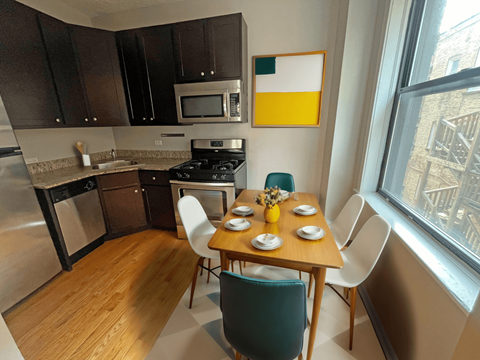 a kitchen and dining room with a table and chairs