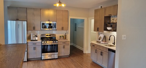 a kitchen with stainless steel appliances and wooden cabinets