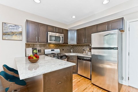 a kitchen with stainless steel appliances and a counter top