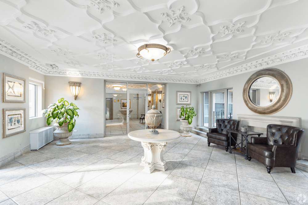 A white room with a round mirror and a table.