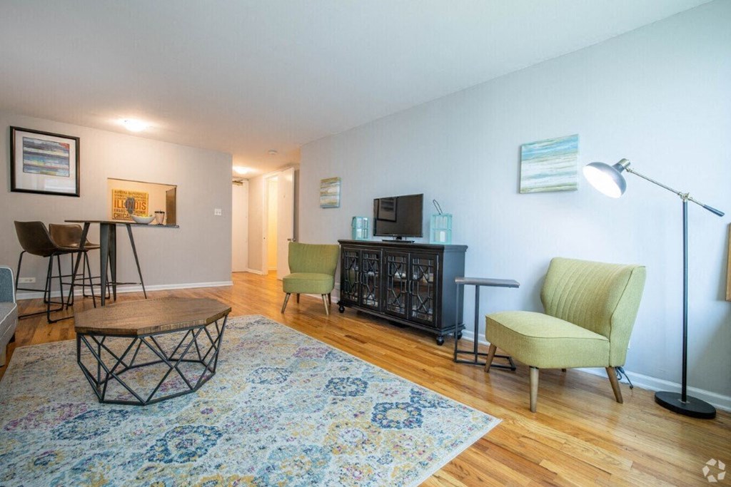 a living room with a couch and chairs and a table
