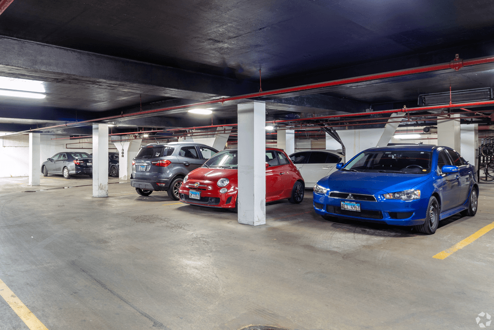 a parking garage with cars parked in it at The Bryn - 5600 N Sheridan Rd Apartments, Chicago, 60660