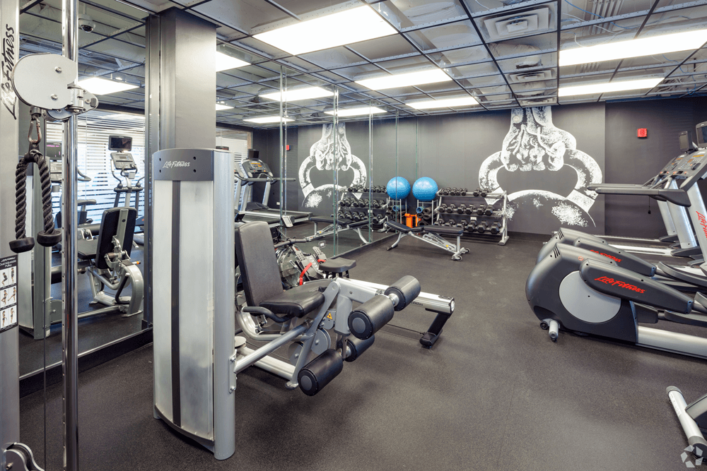 a gym with weights and other exercise equipment at The Bryn - 5600 N Sheridan Rd Apartments, Illinois, 60660
