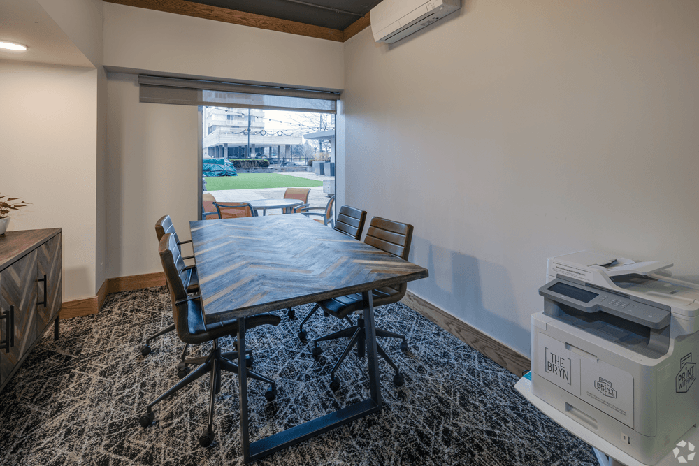 A room with a table, chairs, and a printer at The Bryn - 5600 N Sheridan Rd Apartments, Chicago, 60660