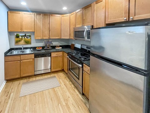 a kitchen with stainless steel appliances and wooden cabinets