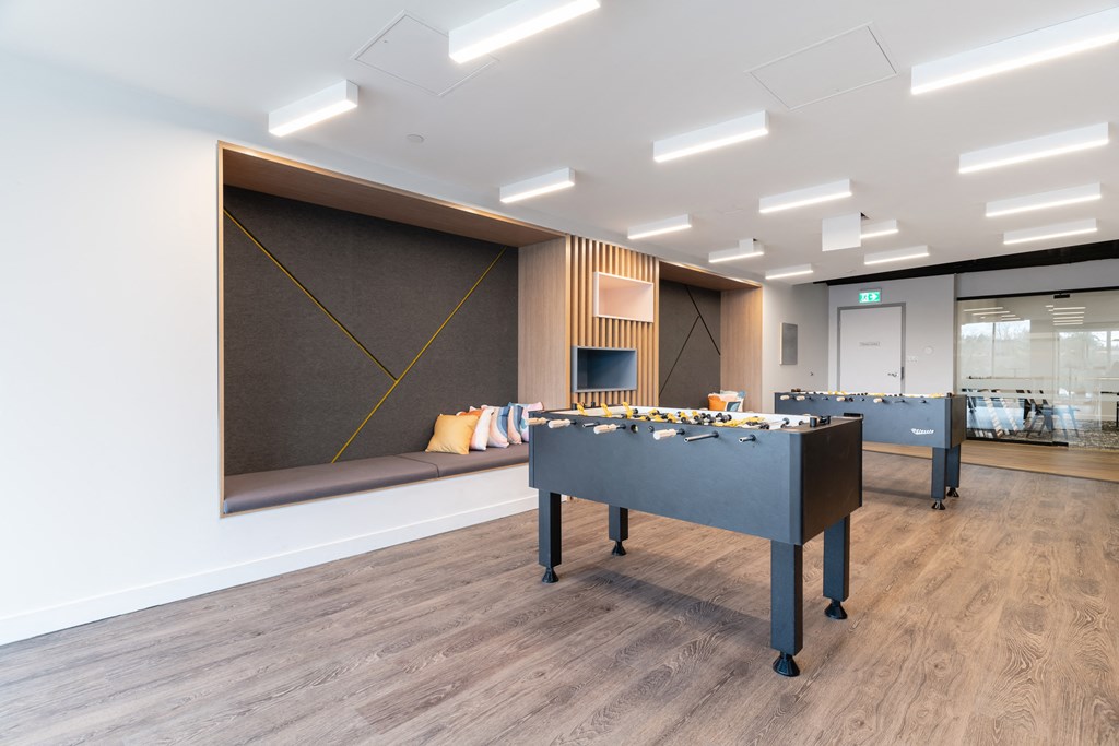 a game room with a foosball table and a window