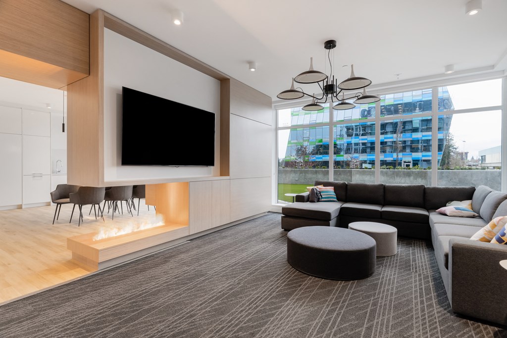 a living room with couches and a tv on the wall