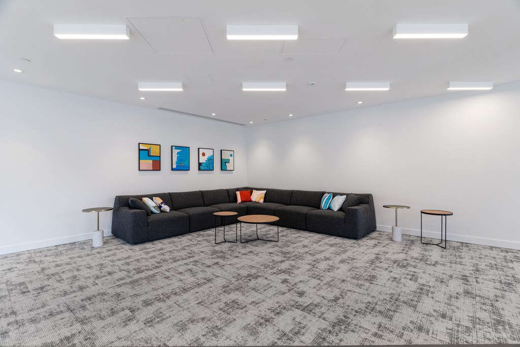 a large living room with a couch and tables