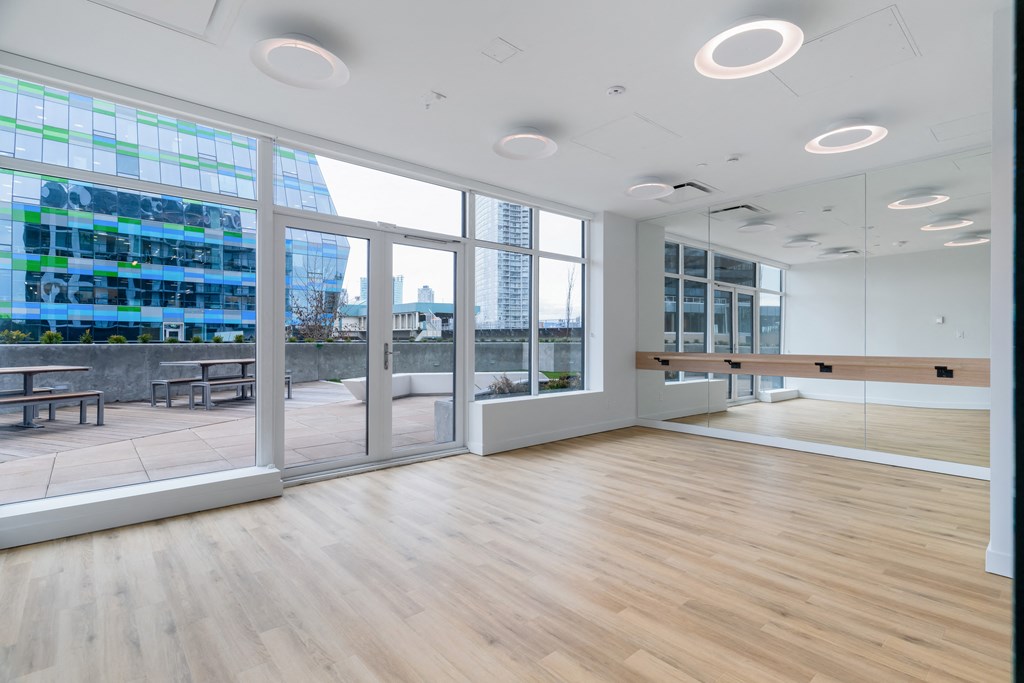 a large room with a wood floor and large windows