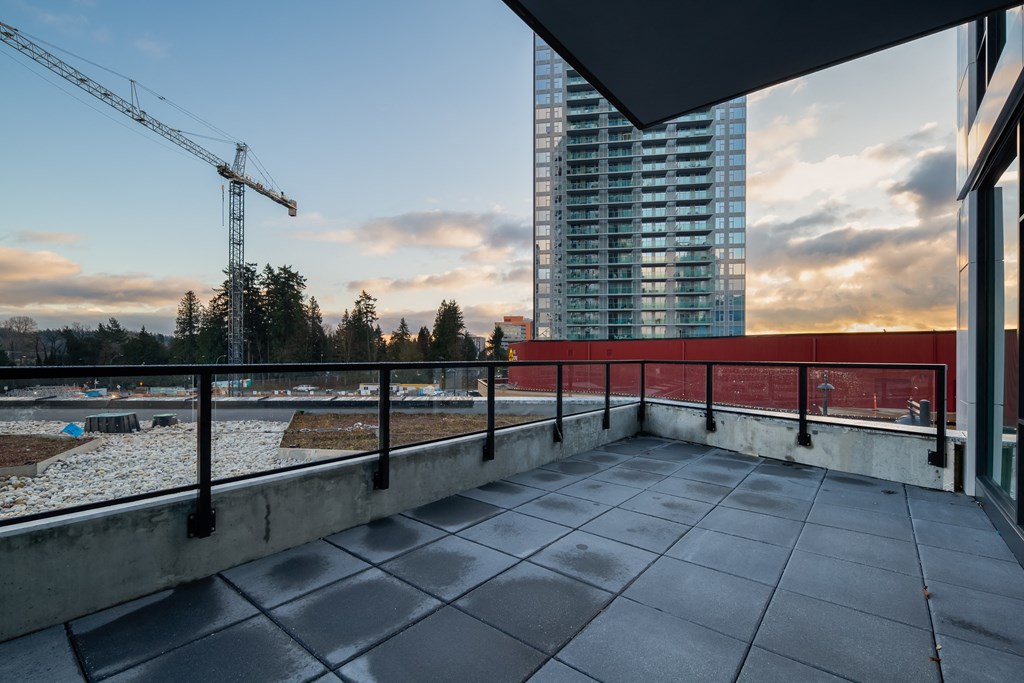 a balcony with a view of a construction site and a skyscraper
