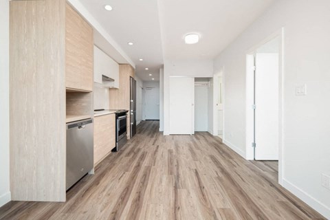 A kitchen with wooden floors and white walls.